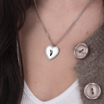Silver zirconia heart necklace footprint flat lay – personalized keepsake VECINO