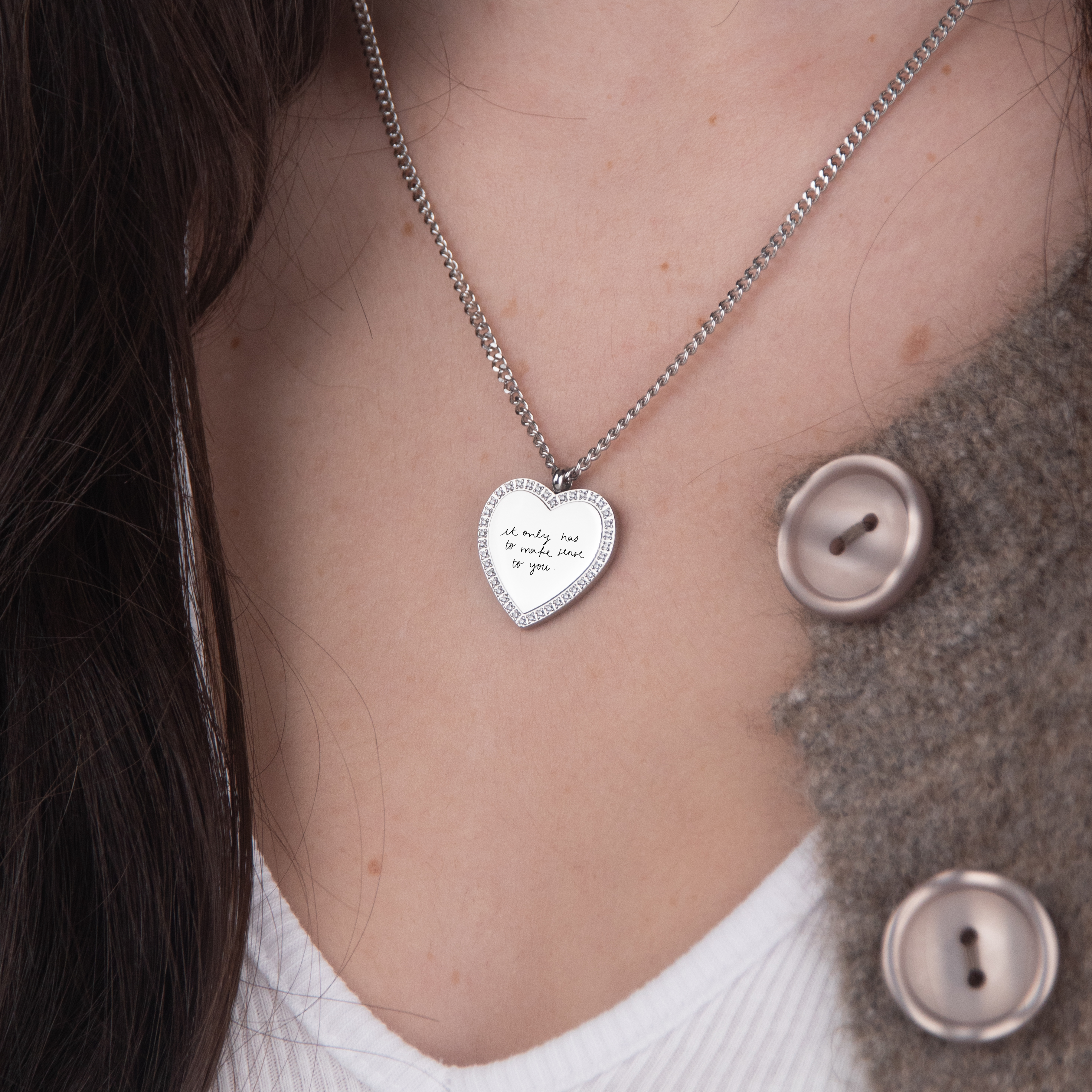Silver zirconia heart necklace handwriting flat lay – personalized jewelry VECINO