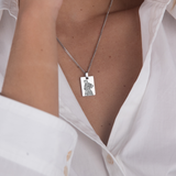 Silver pet silhouette necklace flat lay – personalized pet portrait jewelry VECINO
