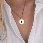 Gold zirconia round necklace footprint flat lay – 18K personalized keepsake VECINO