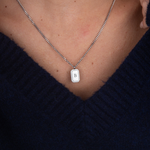Silver zirconia square necklace initial flat lay – personalized jewelry VECINO