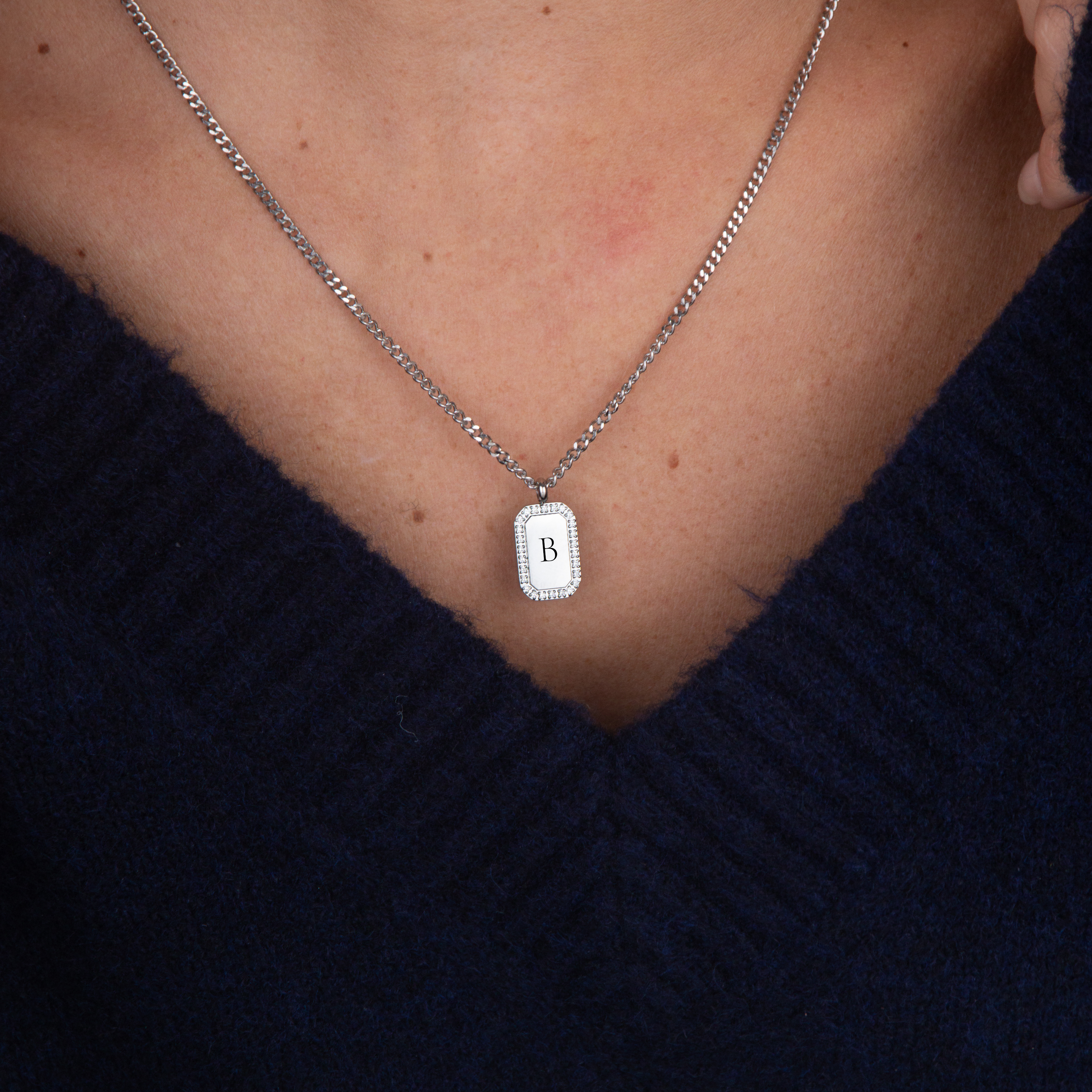 Silver zirconia square necklace initial flat lay – personalized jewelry VECINO